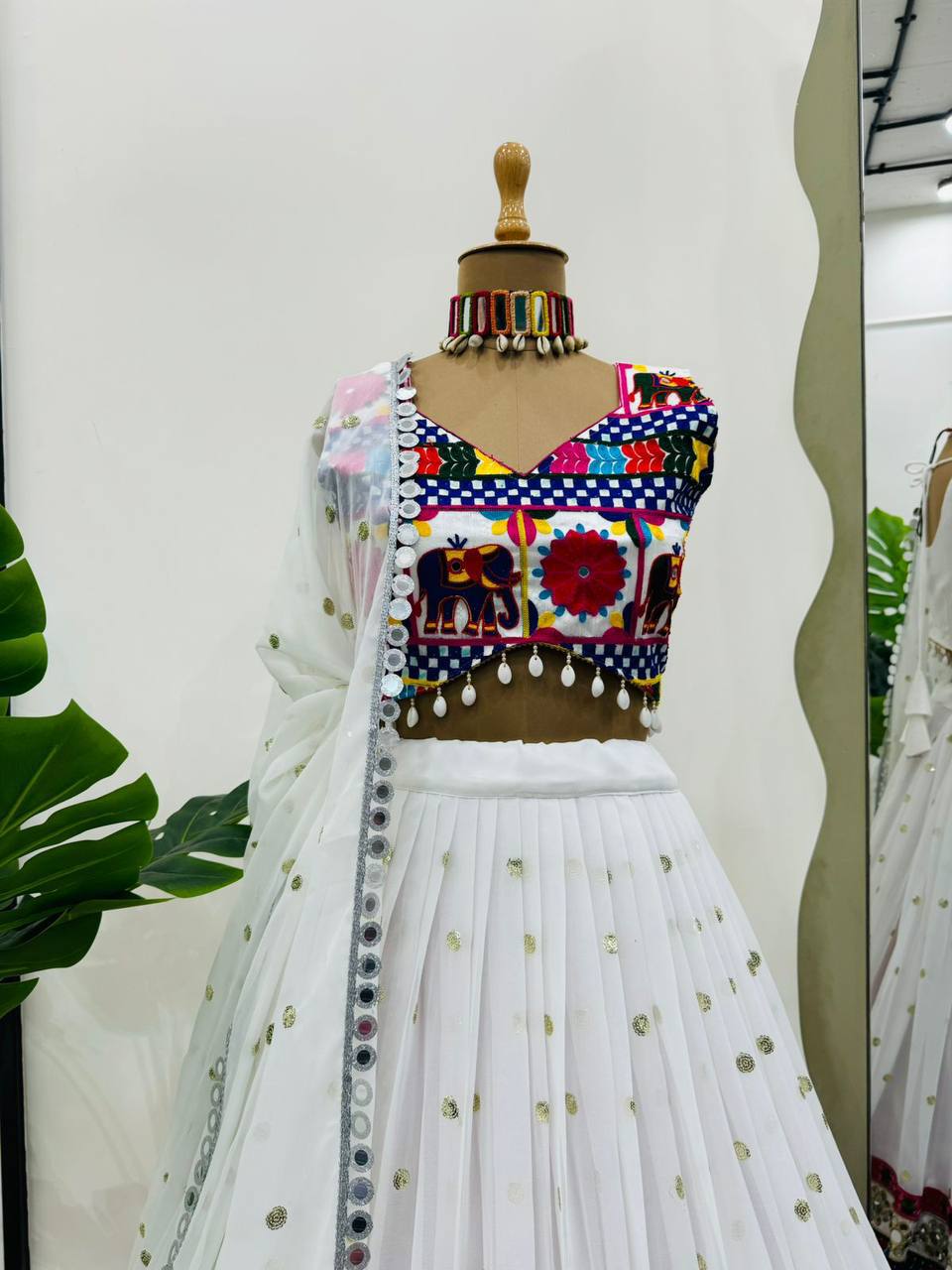 Exquisite Pristine White Designer Lehenga Choli with Vibrant Multicolored Traditional Elephant Embroidery and Mirror Work Detailing